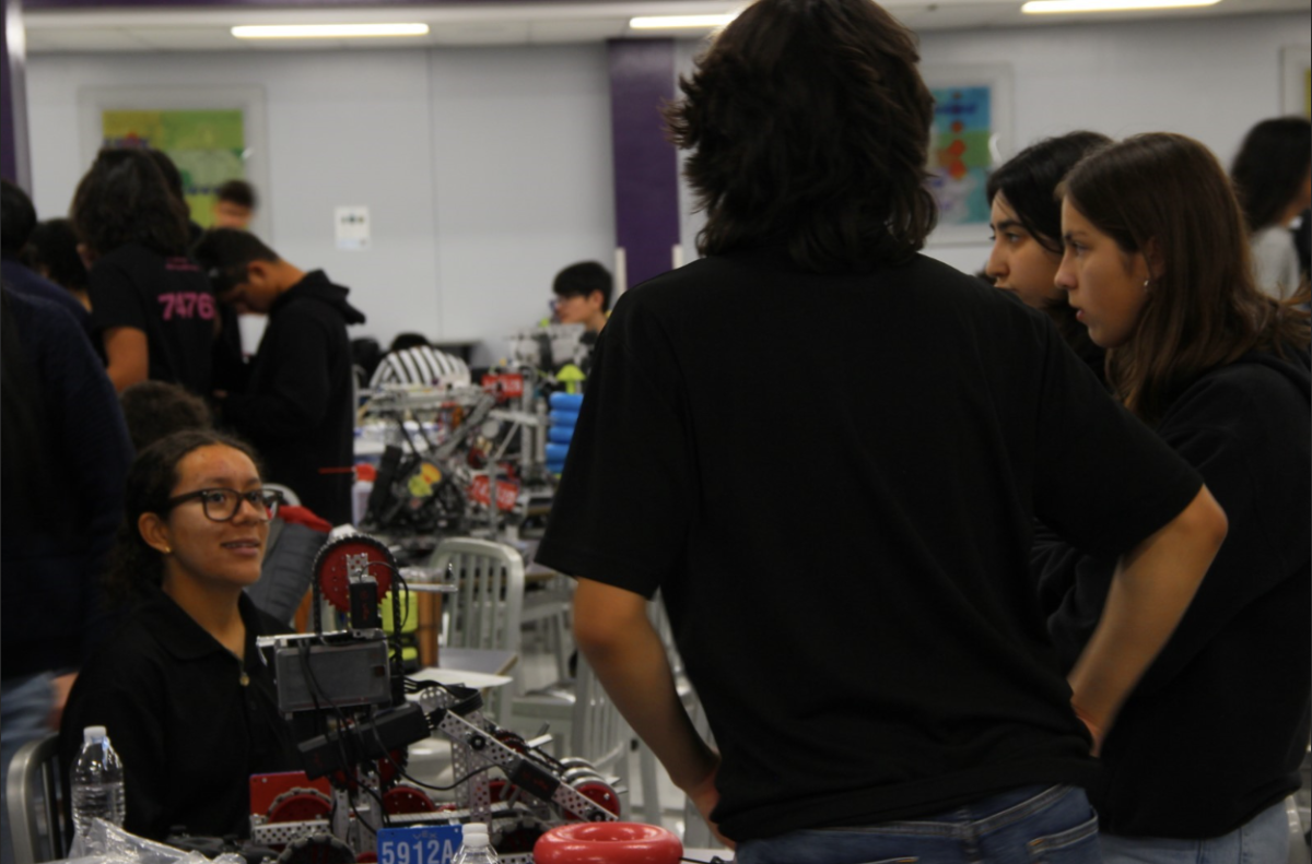 Studens from El Paso High School robotics team codename ”Tigertronics” discuss any changes on the robot before their first match.